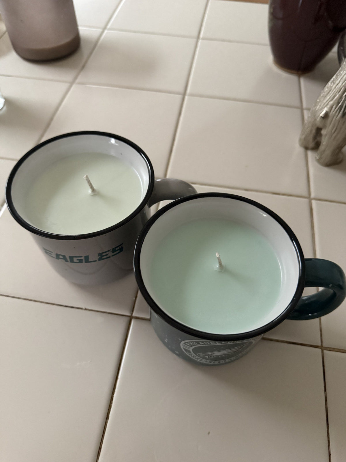 Top view of both Eagles mug candles showing the wax and wicks