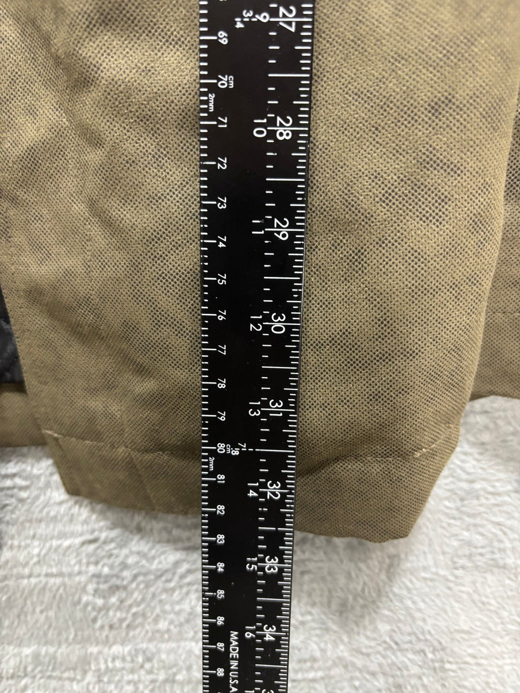 My Second Story olive field jacket sleeve detail with measuring tape showing length