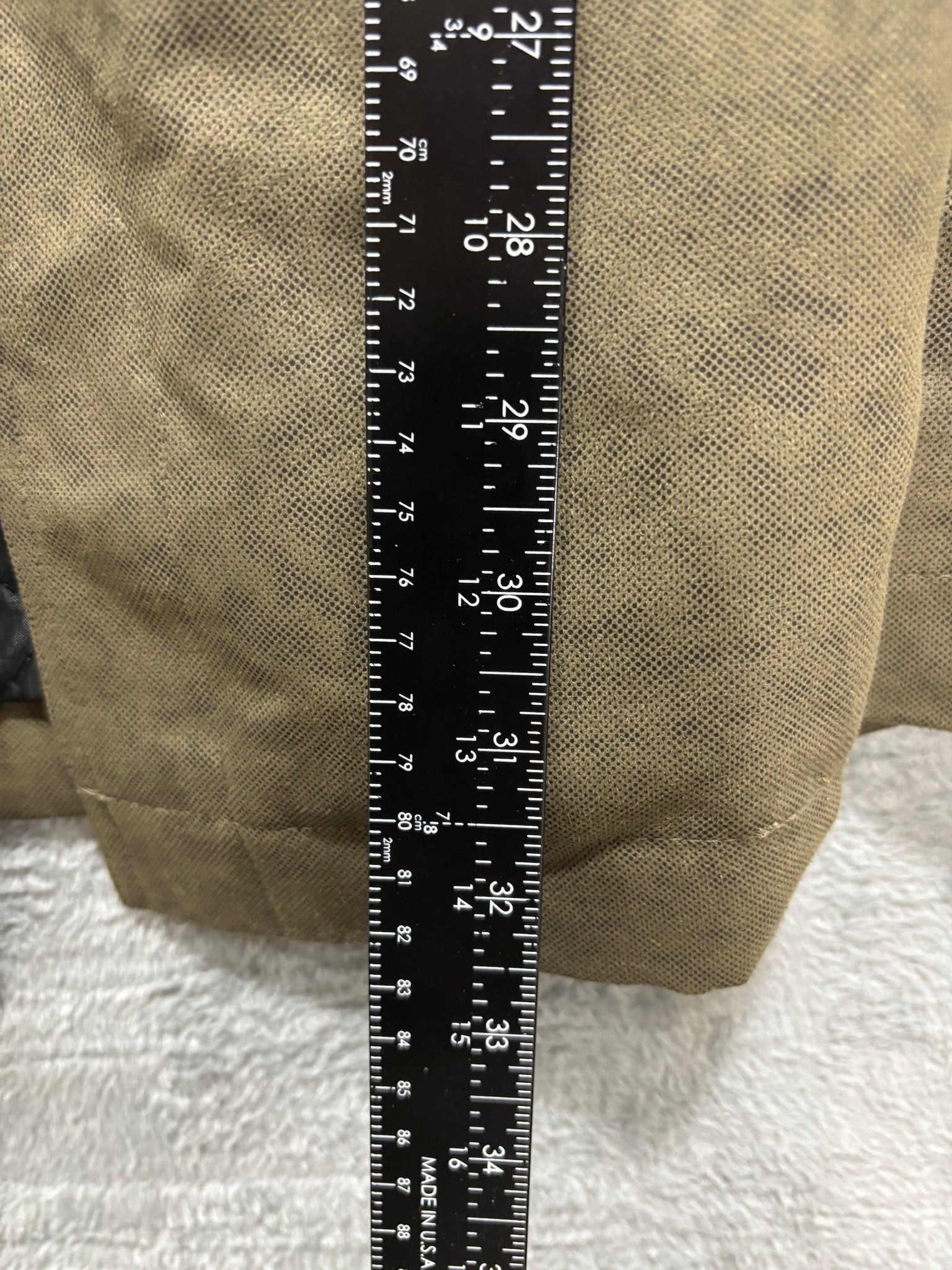 My Second Story olive field jacket sleeve detail with measuring tape showing length