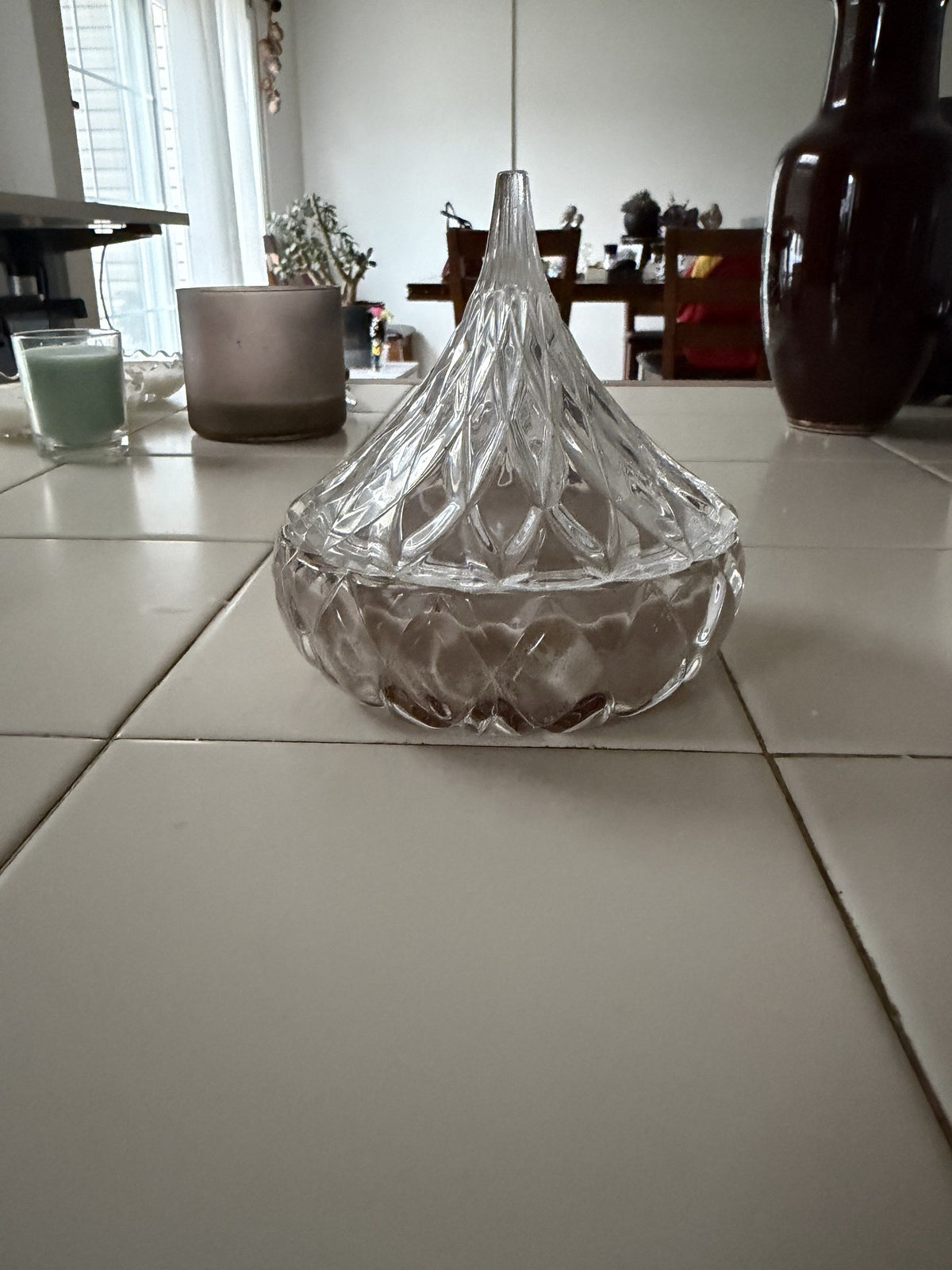 Sealed With a Kiss candle with its pointed glass lid closed